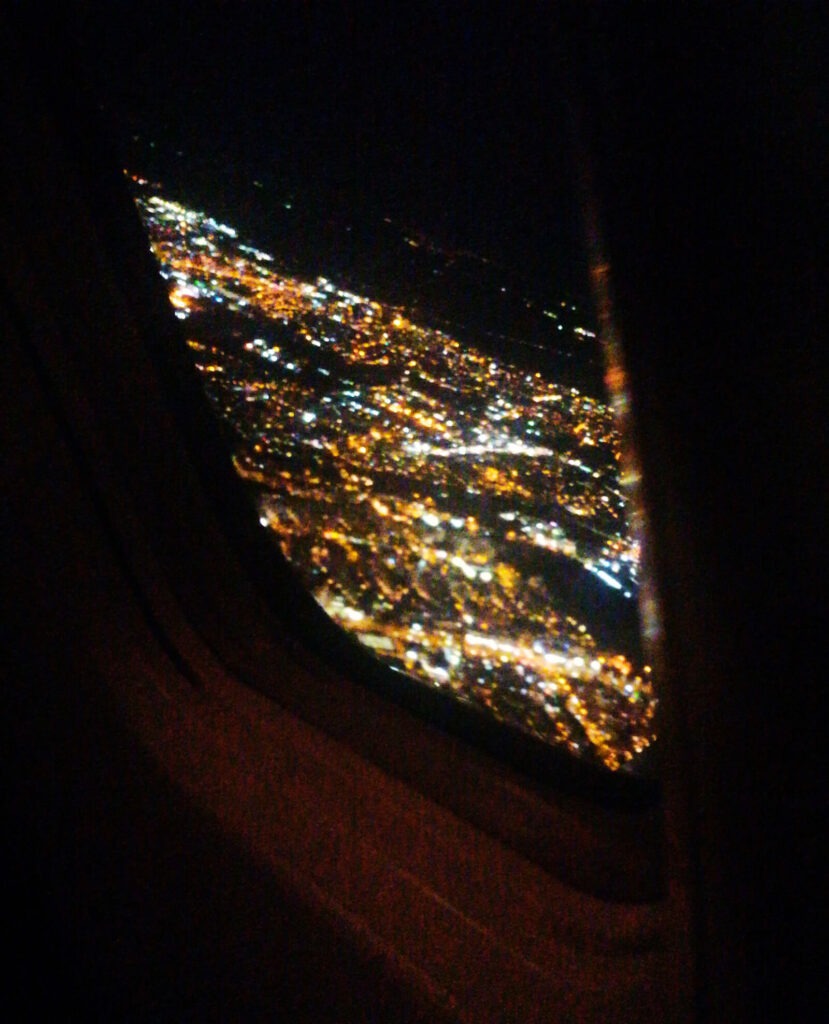 Photo: a view from airplane window at night on city lights